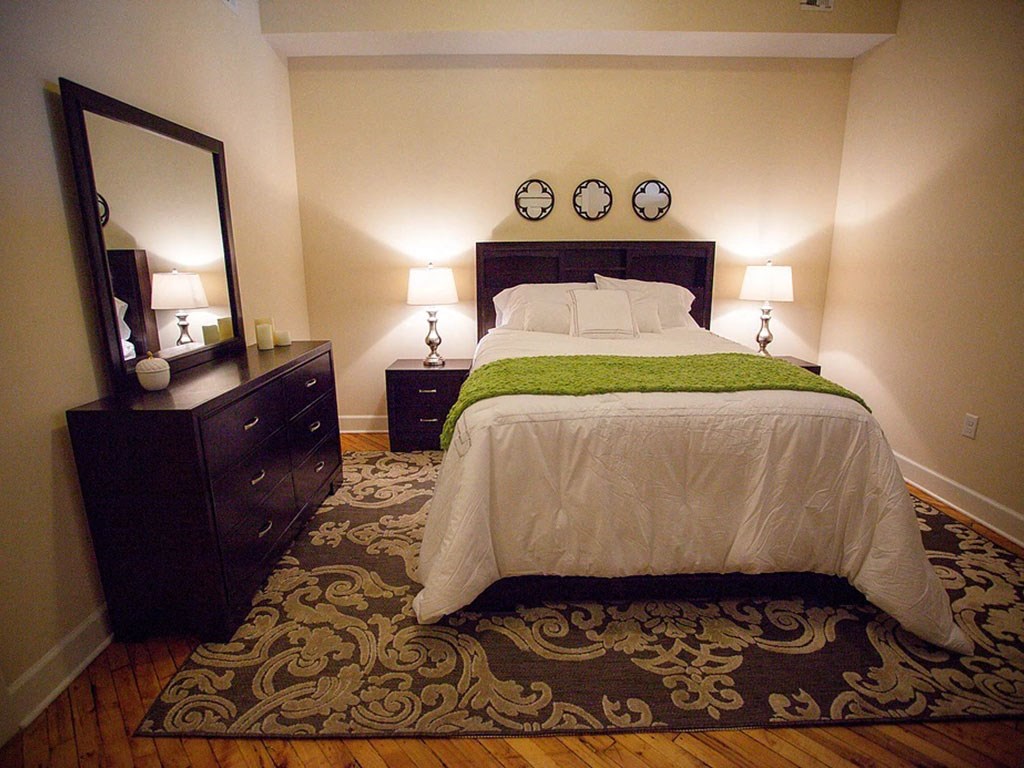 a bedroom with a bed and two dressers