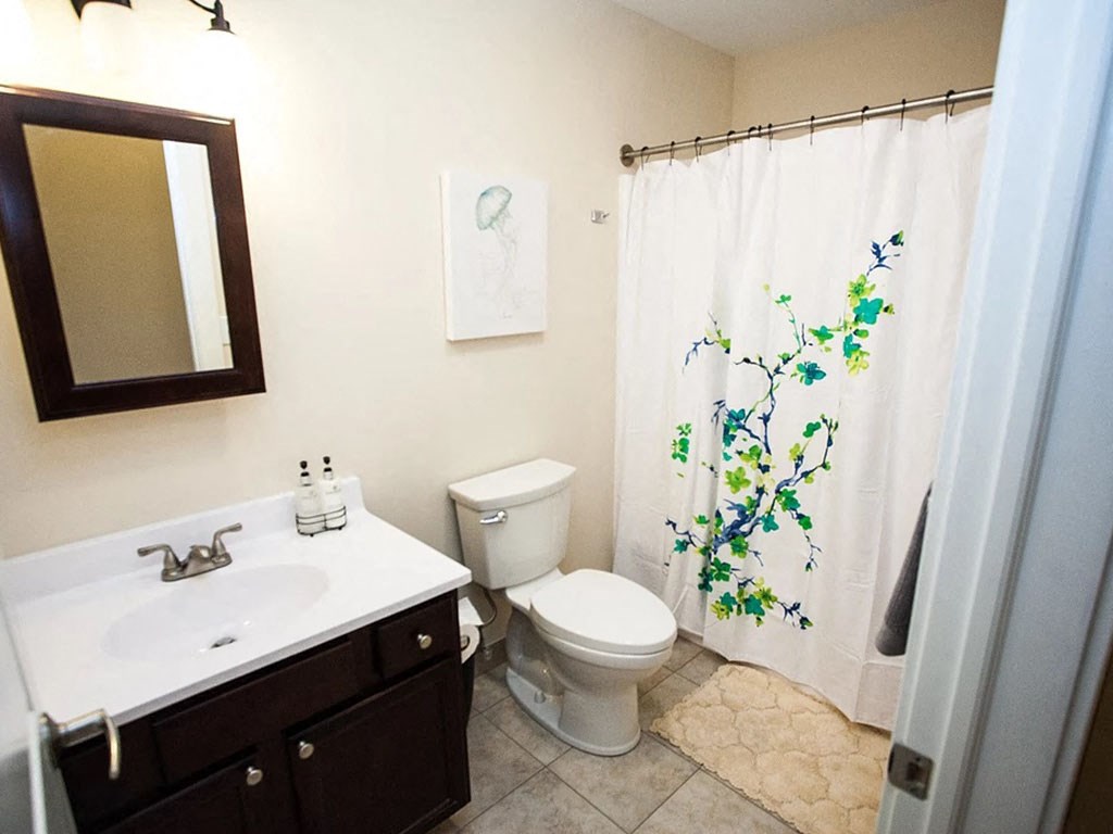 a bathroom with a toilet and a sink and a shower