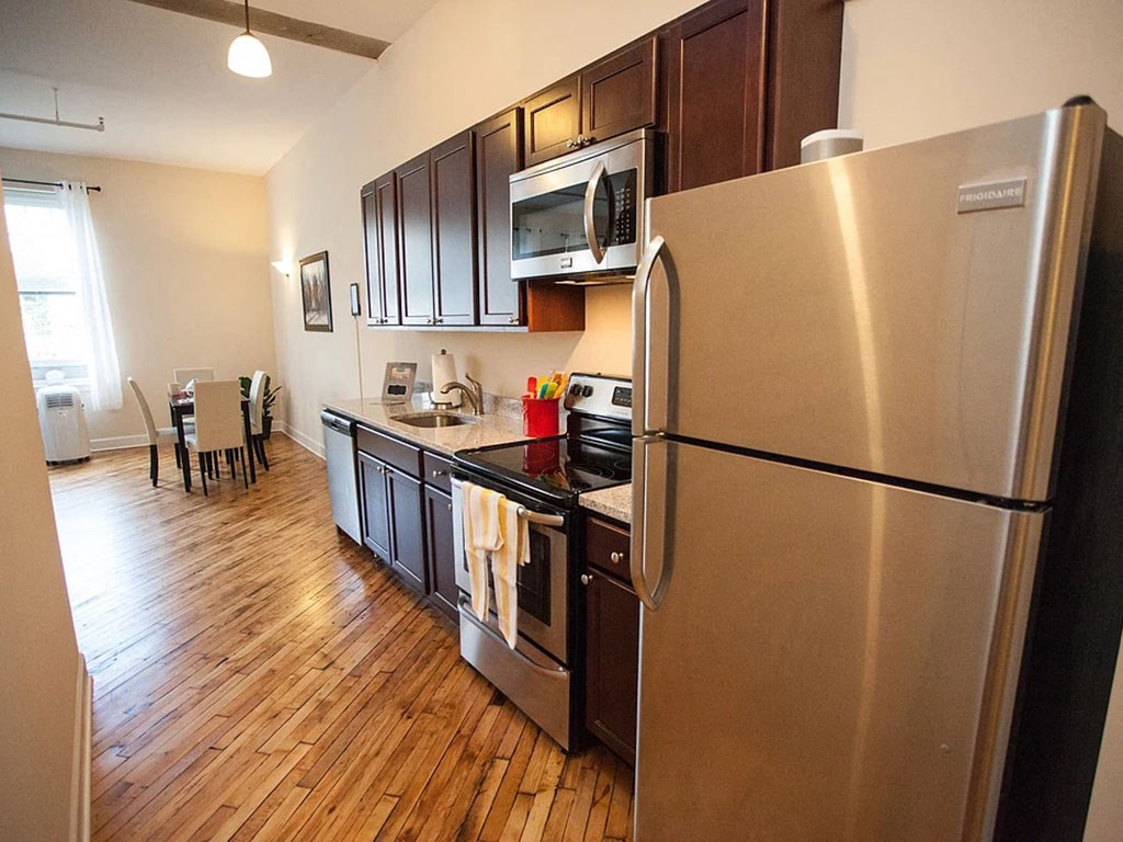 a kitchen with stainless steel appliances and a refrigerator