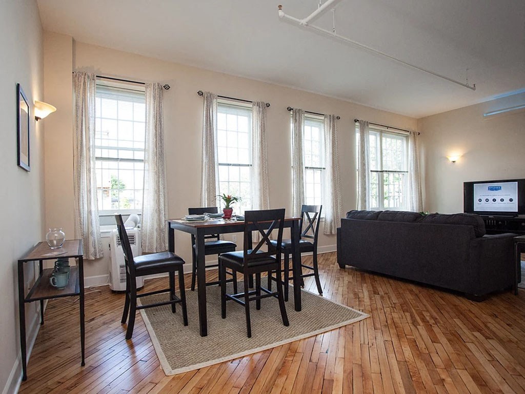 a living room with a table and chairs and a couch