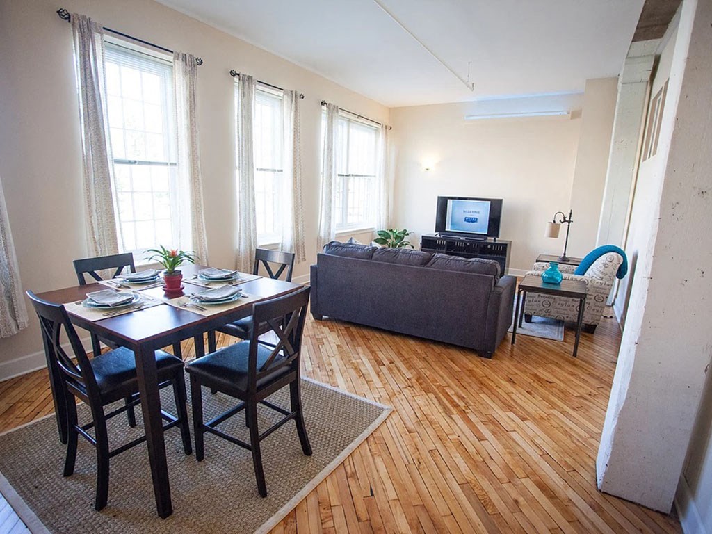 a living room with a table and a couch and a tv