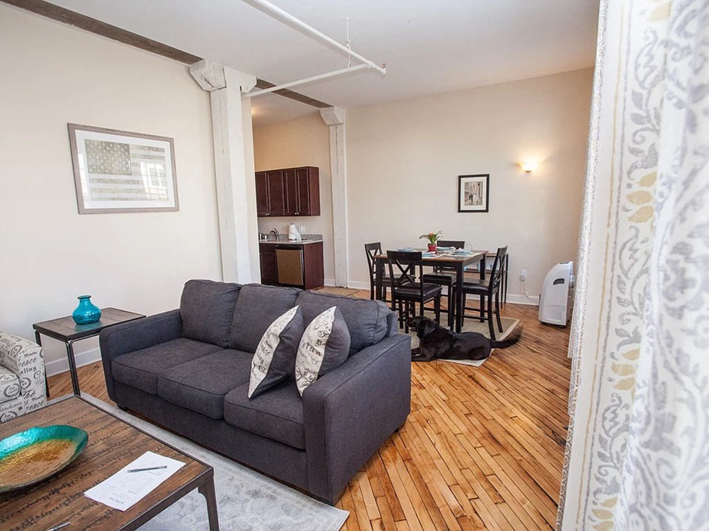 a living room with a couch and a dining room
