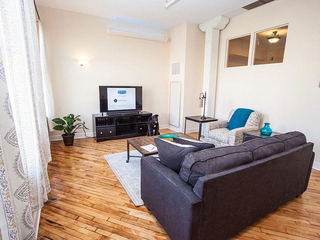 a living room with a couch and a tv