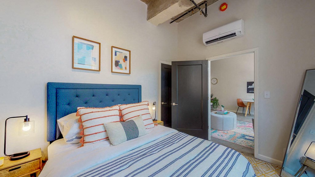 a bedroom with a bed and a tv