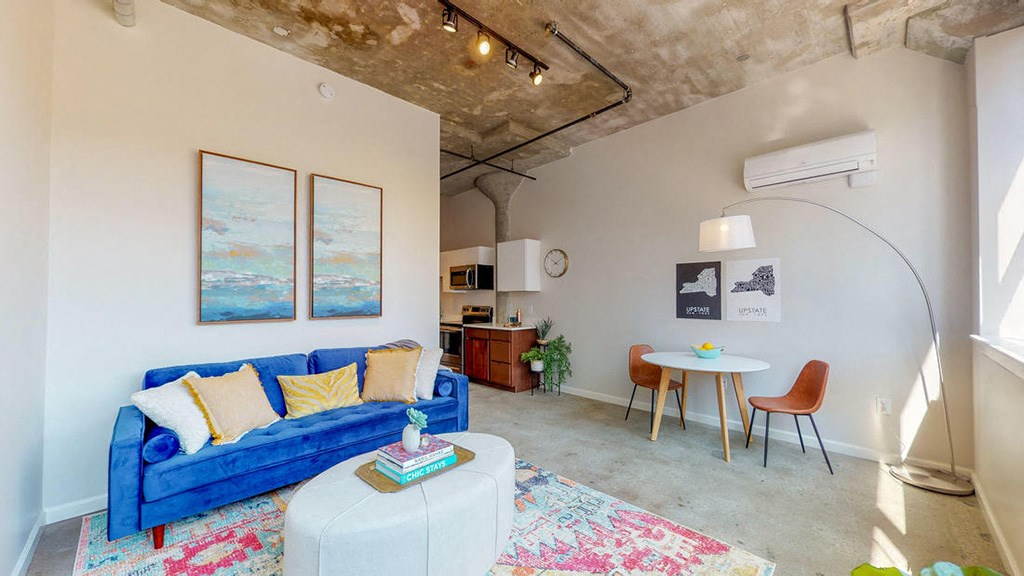 a living room with a blue couch and a table