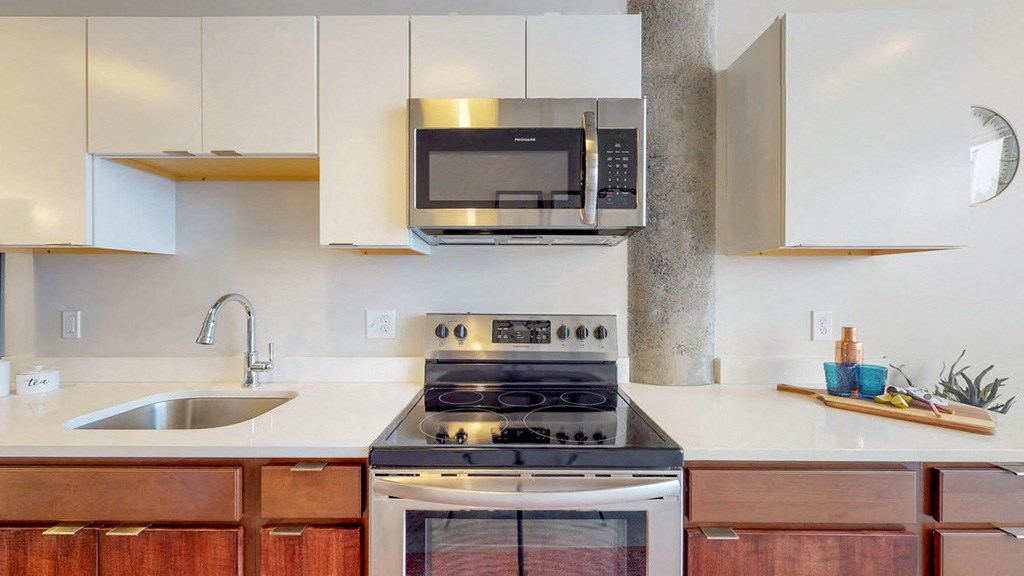 a kitchen with a stove microwave and sink