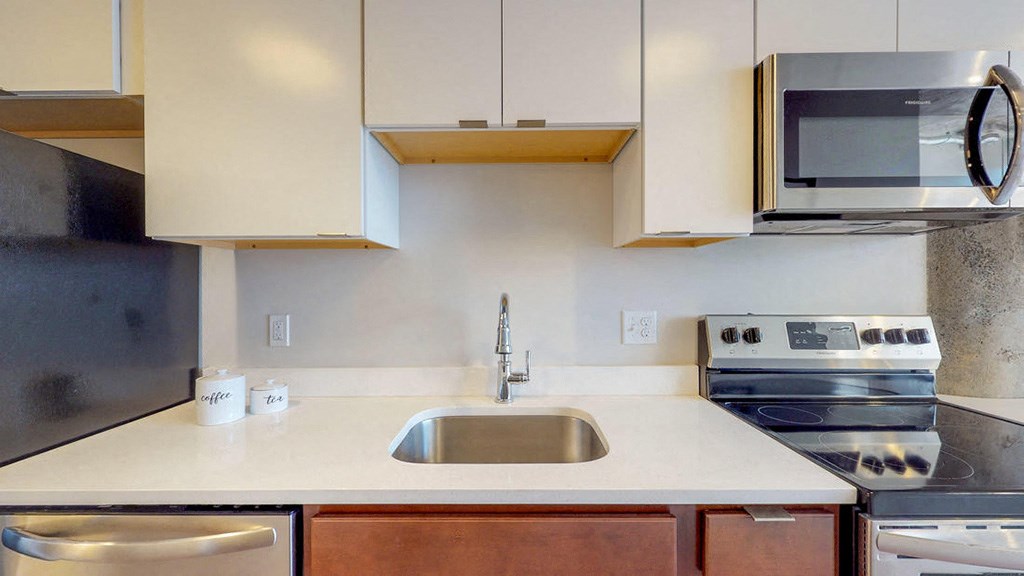 a kitchen with a sink and a microwave