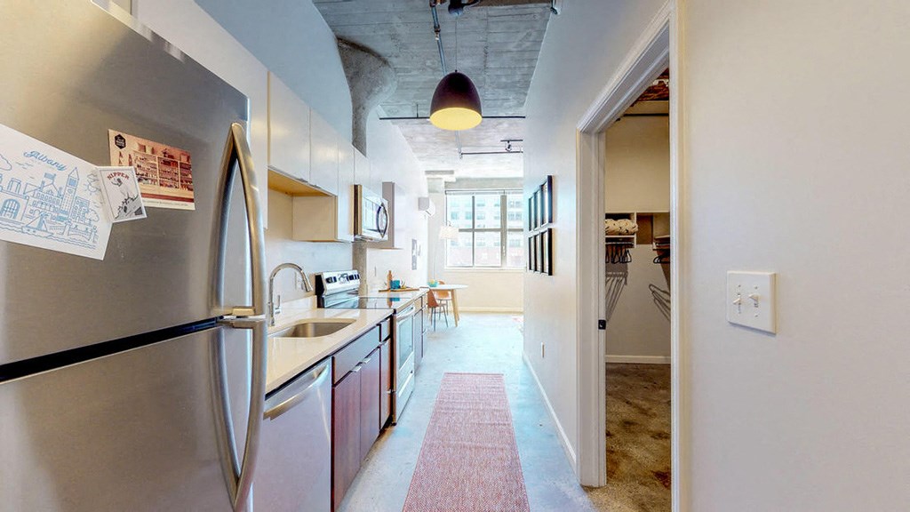 a kitchen with a stainless steel refrigerator and a sink