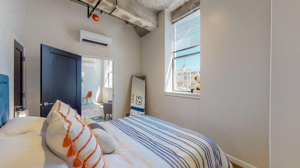 a bedroom with a bed and a window