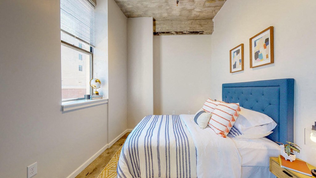 a bedroom with a bed and a window