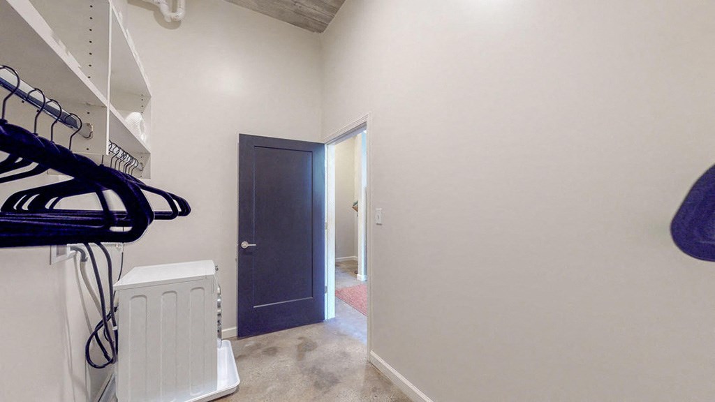 a room with a closet and a door to a hallway