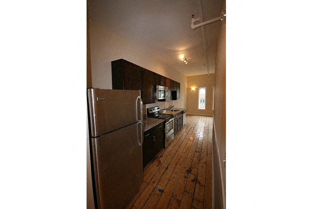 a kitchen with a refrigerator and a stove and