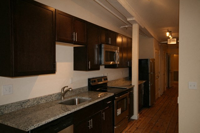 a kitchen with granite counter tops and a sink