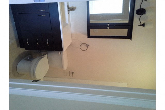 a bathroom with a toilet and a sink and a mirror