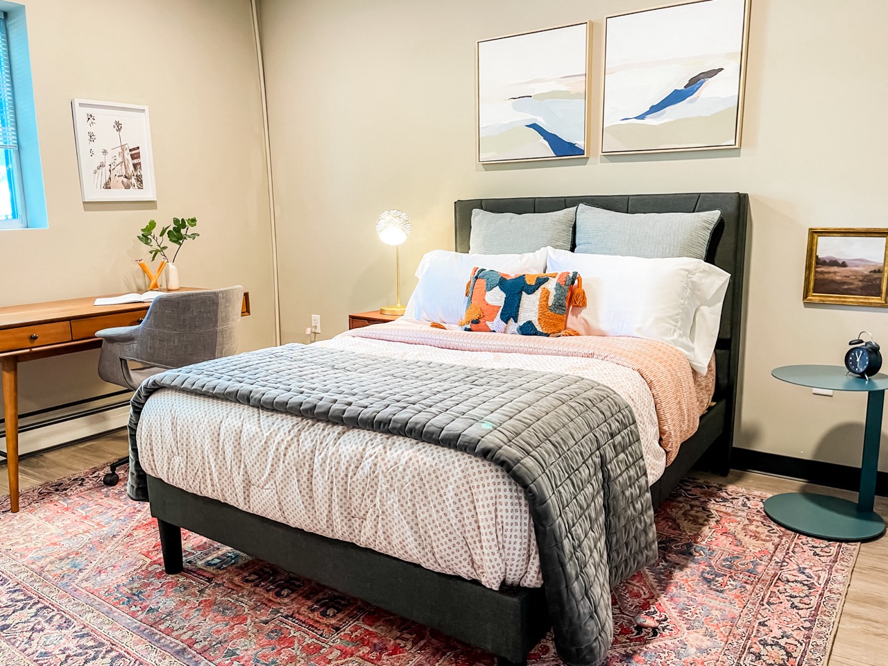 a bedroom with a bed and a desk with a chair