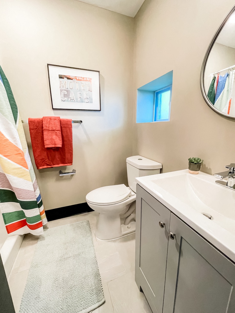 a bathroom with a sink toilet and a mirror