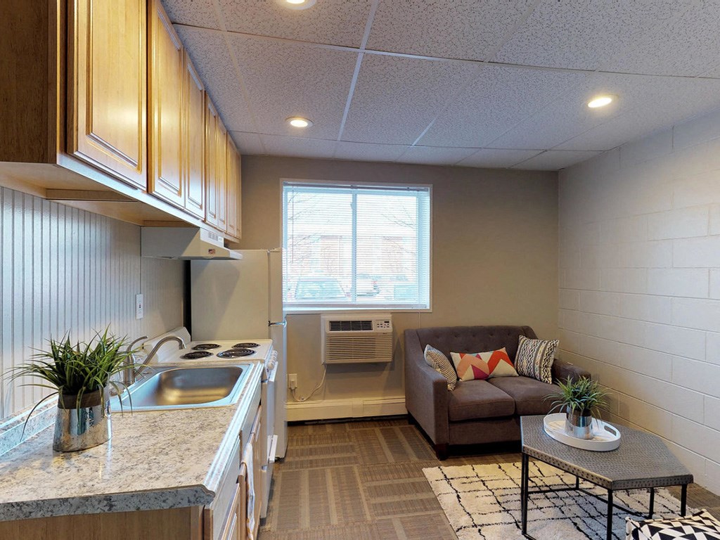 a small living room with a couch and a kitchen