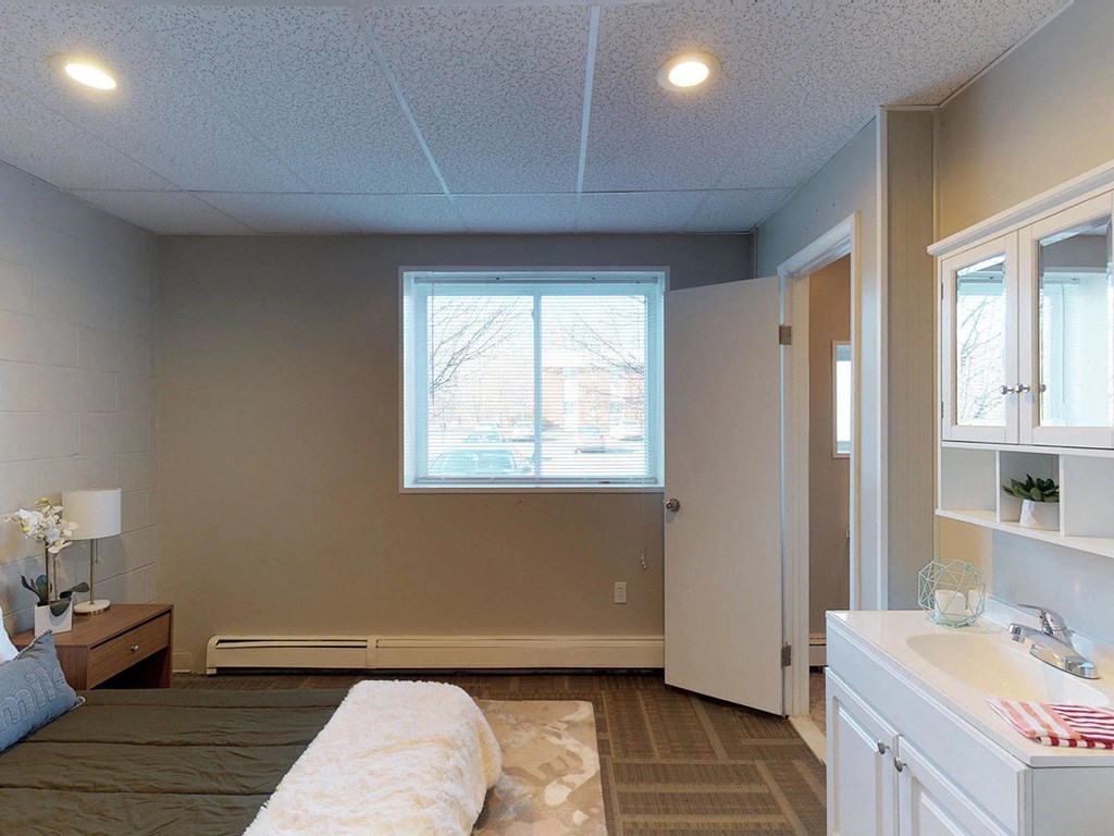 a bedroom with a bed and a window