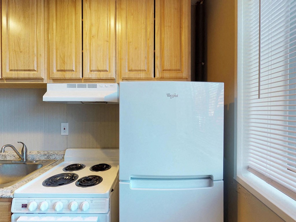 a kitchen with a stove and a refrigerator