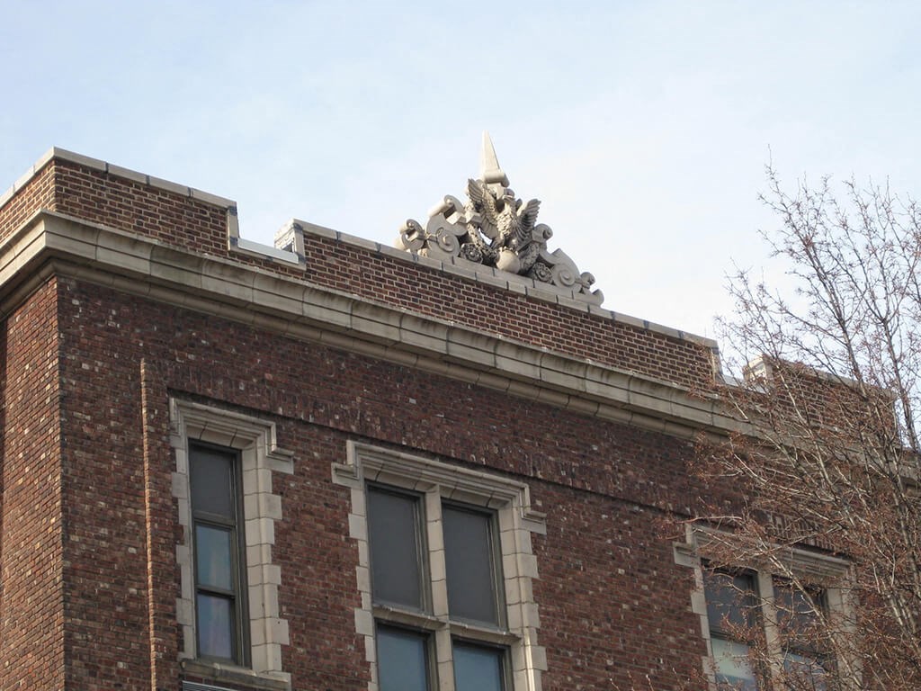 the top of a brick building with a statue on top