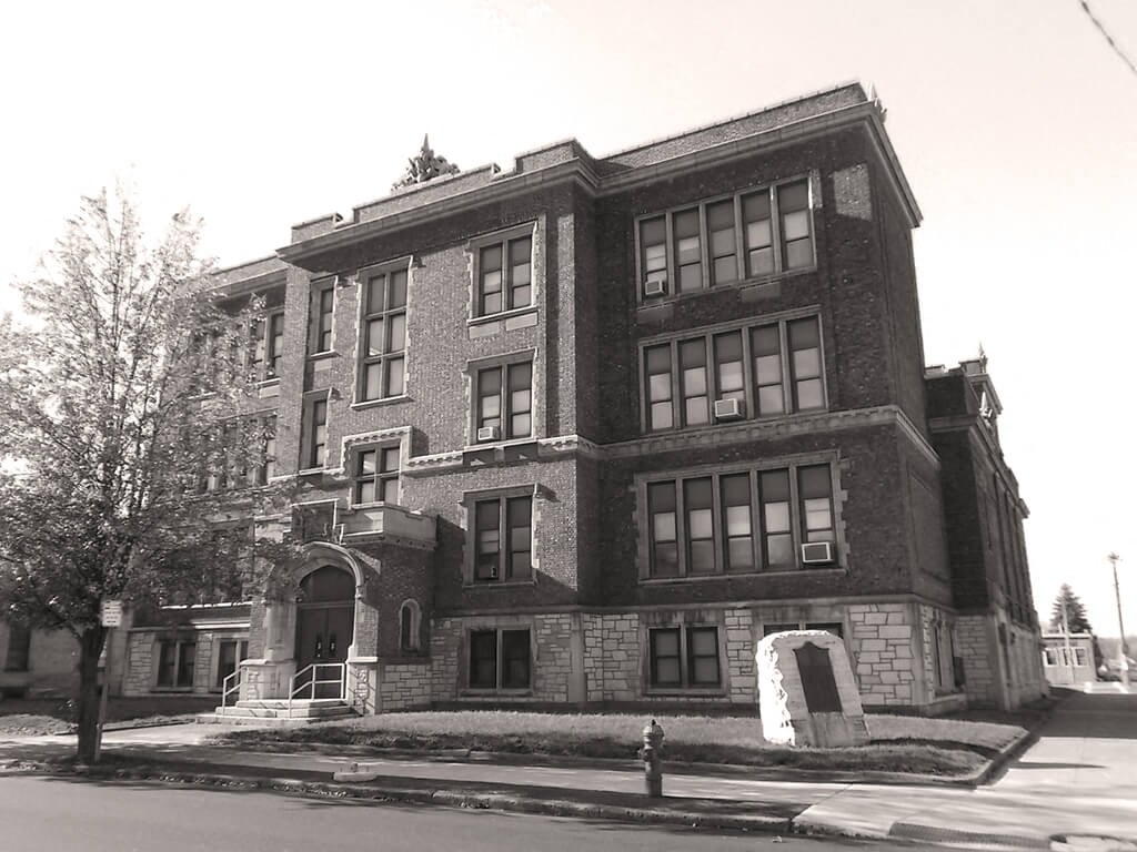 a large brick building on the corner of a street