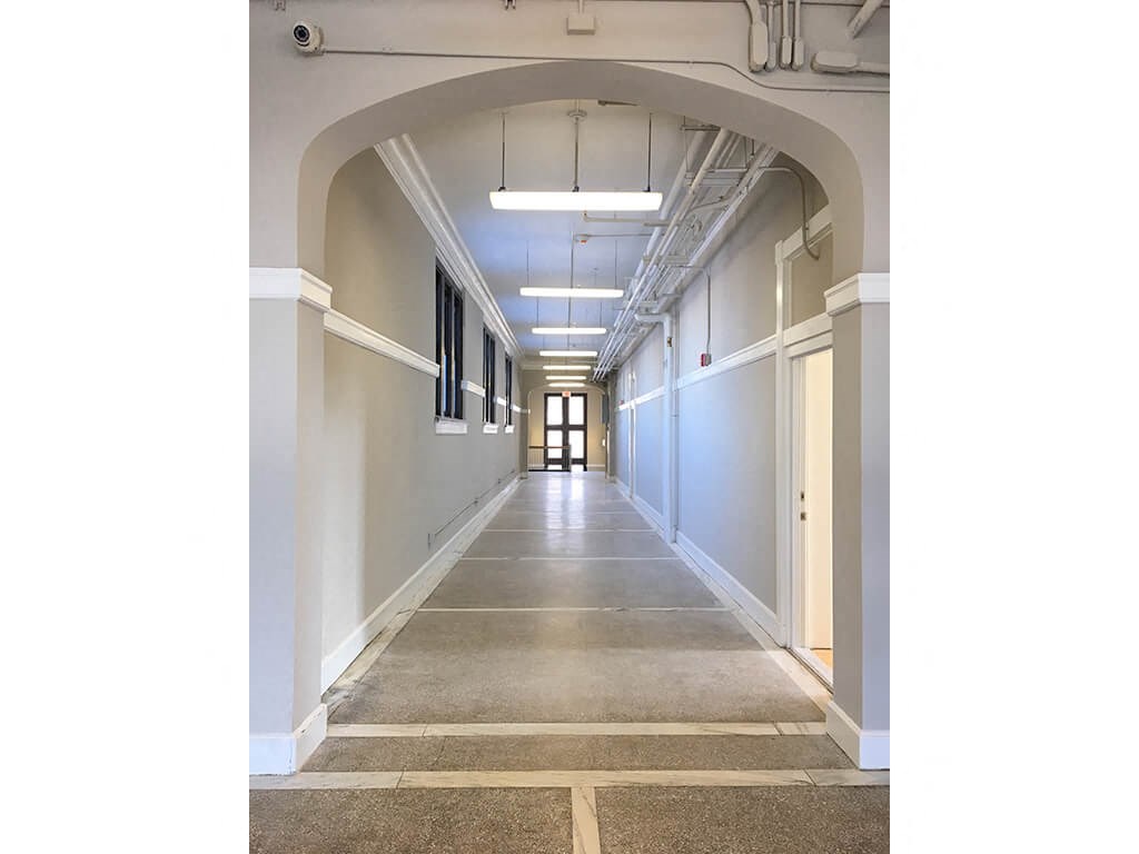 a hallway in a building with an archway