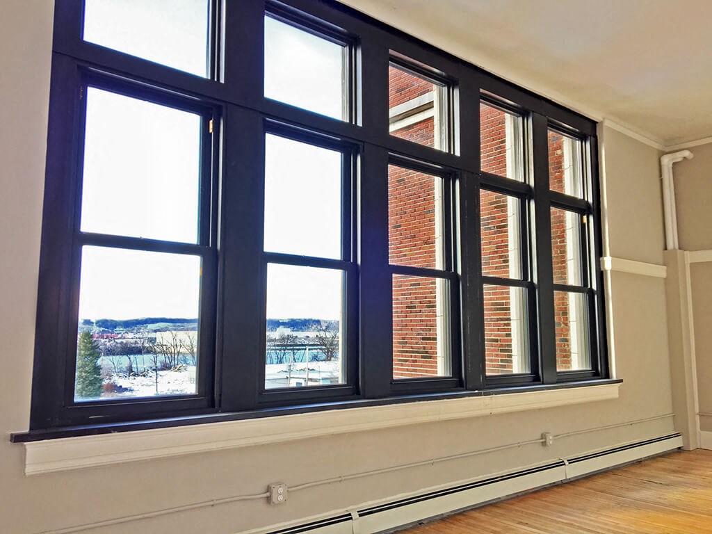 a large window with a view of a brick building