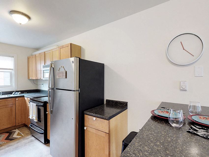 a kitchen with a granite counter top and a refrigerator