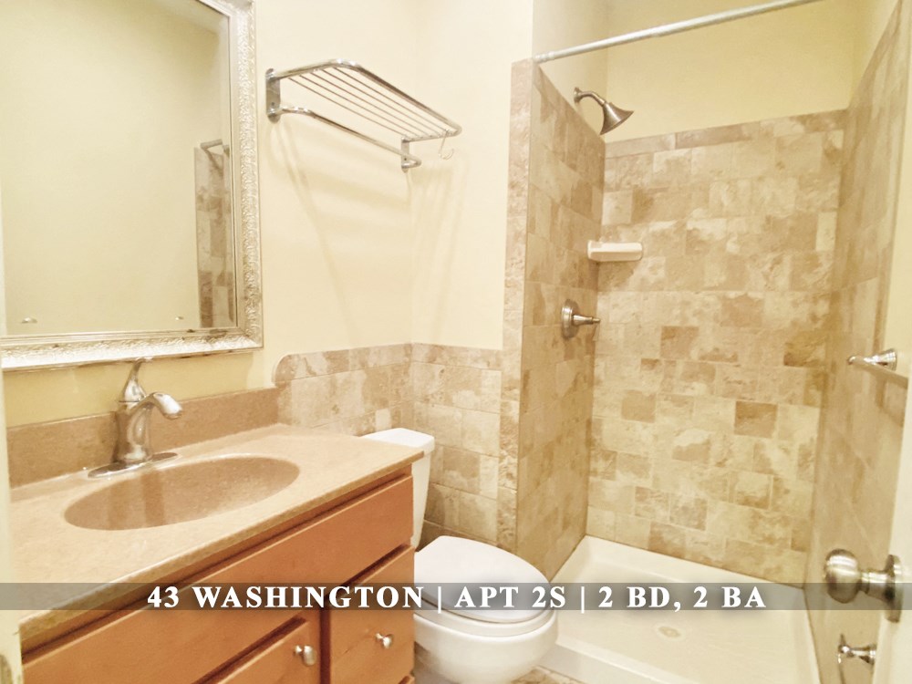 an image of a bathroom with a toilet sink and shower