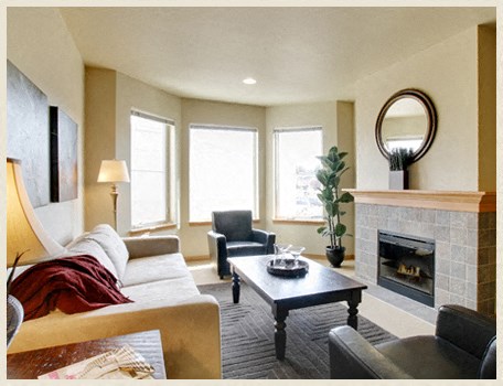 a living room with a couch and a fireplace