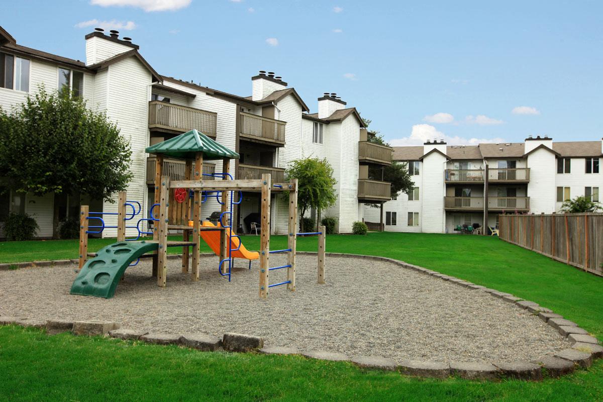 a playground in the middle of an apartment complex