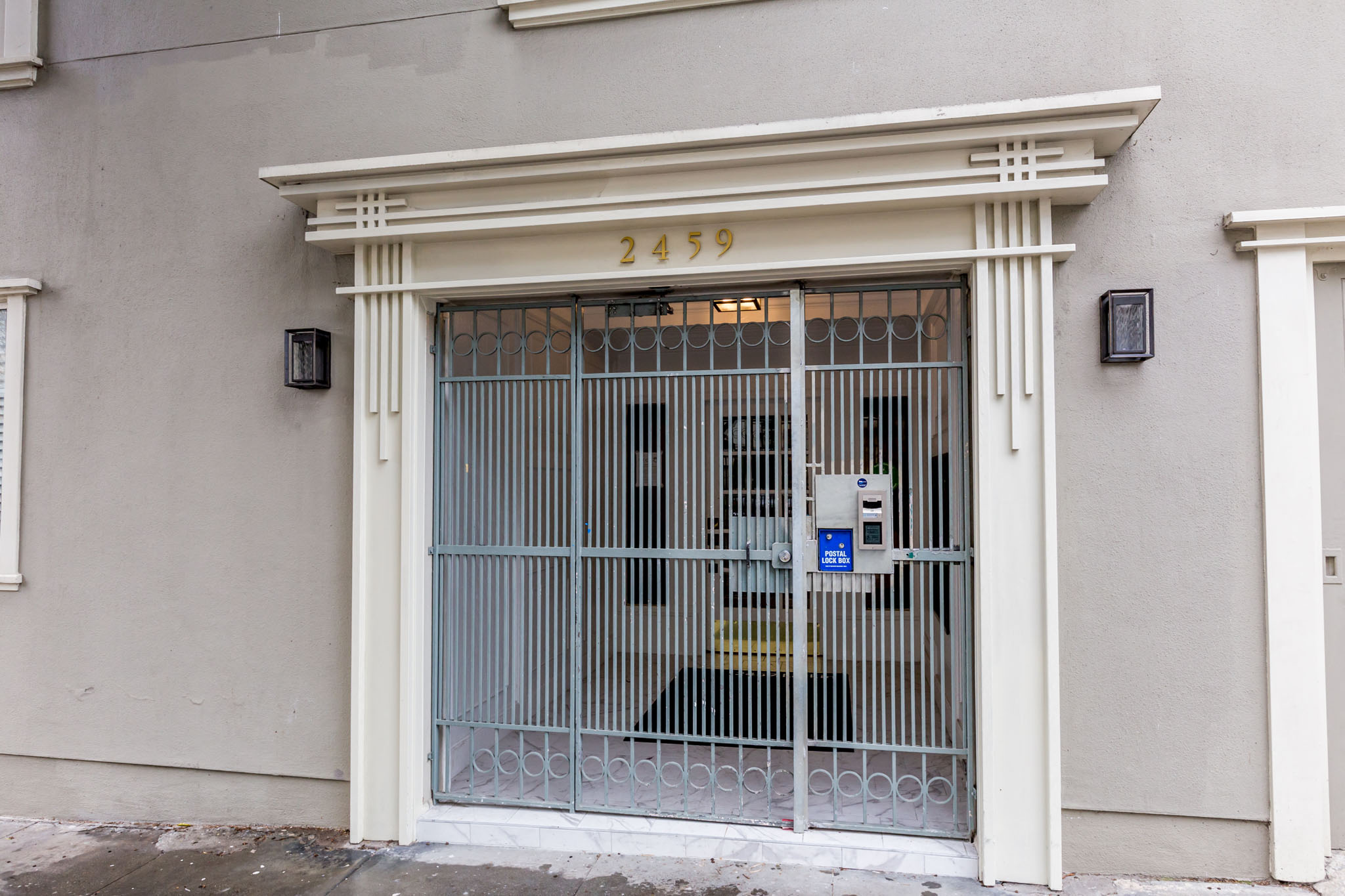 A white building with a number 2459 on the top of the door.