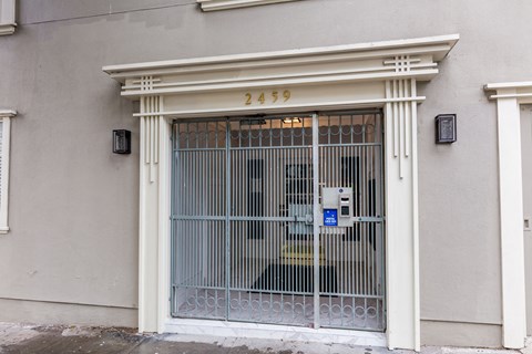 A white building with a number 2459 on the top of the door.