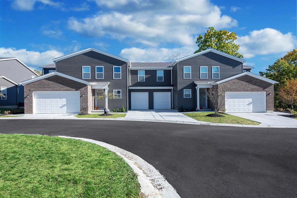 a house with two garage doors and a driveway