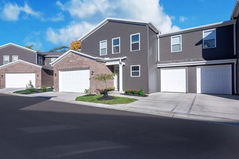 a house with two garage doors on a street