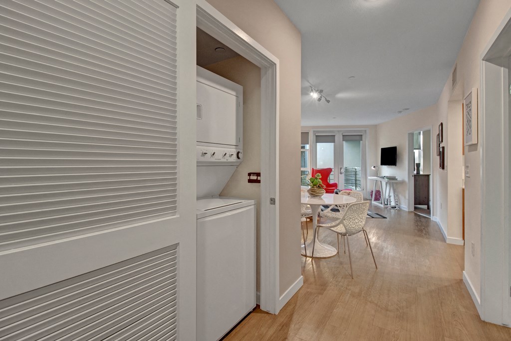 a hallway with an open door to a kitchen and a dining room