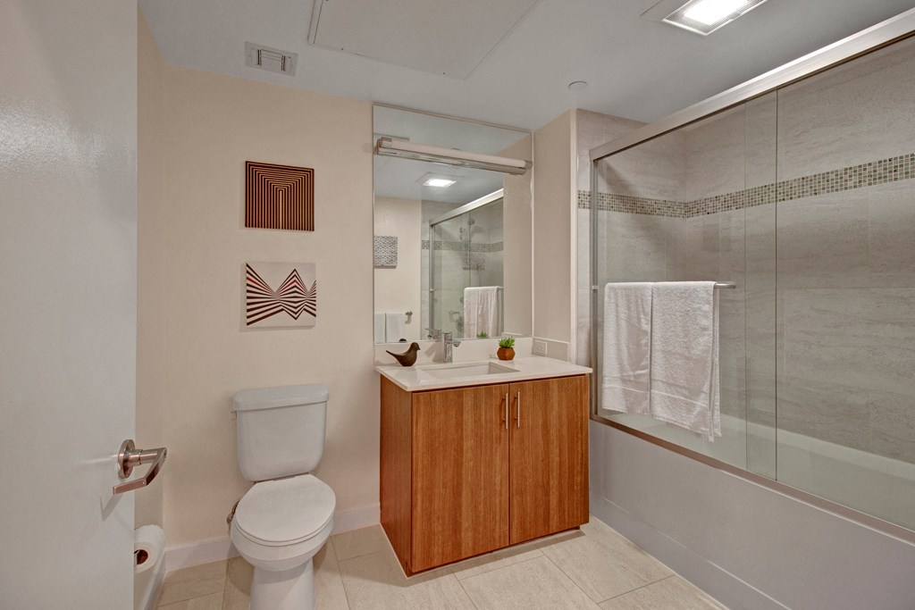 a bathroom with a toilet sink and a shower