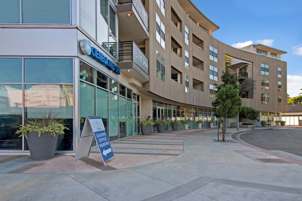 a building with a sign in front of it on a sidewalk
