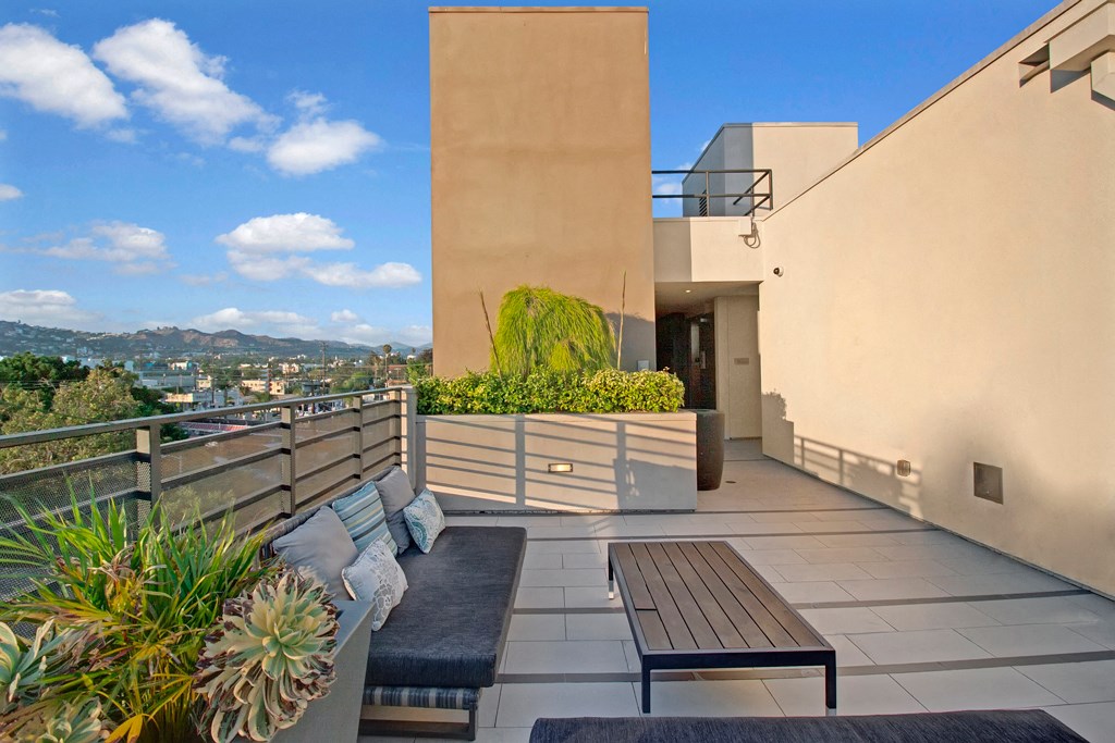 a roof terrace with couches and a table