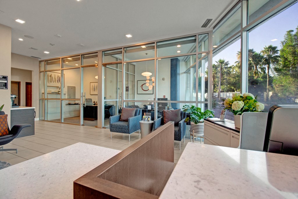 a kitchen and living room with glass doors and windows