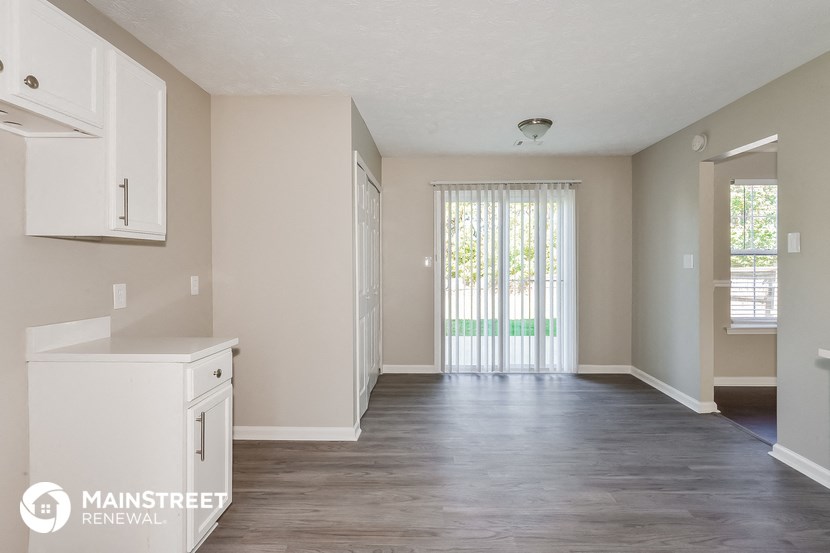 the living room and dining room of an apartment
