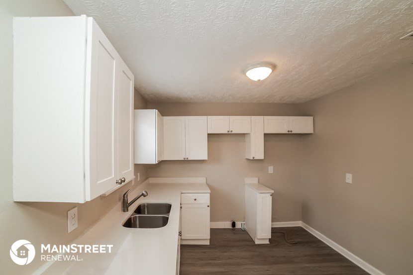 a kitchen with white cabinets and a sink