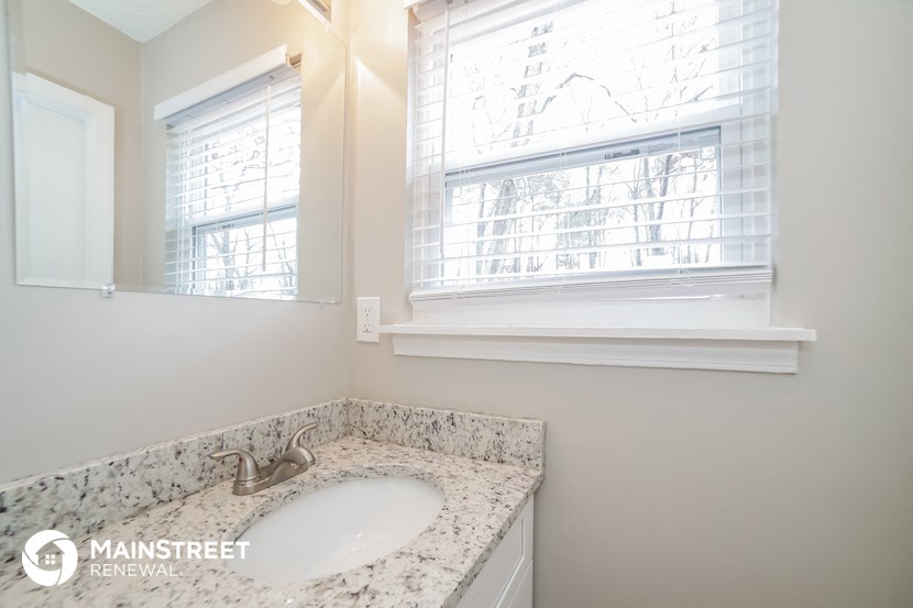 a small bathroom with a sink and a window