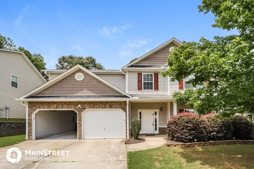 a house with two garage doors on a driveway