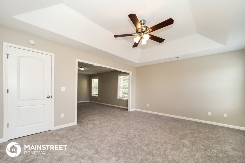 the master bedroom is spacious and has a ceiling fan