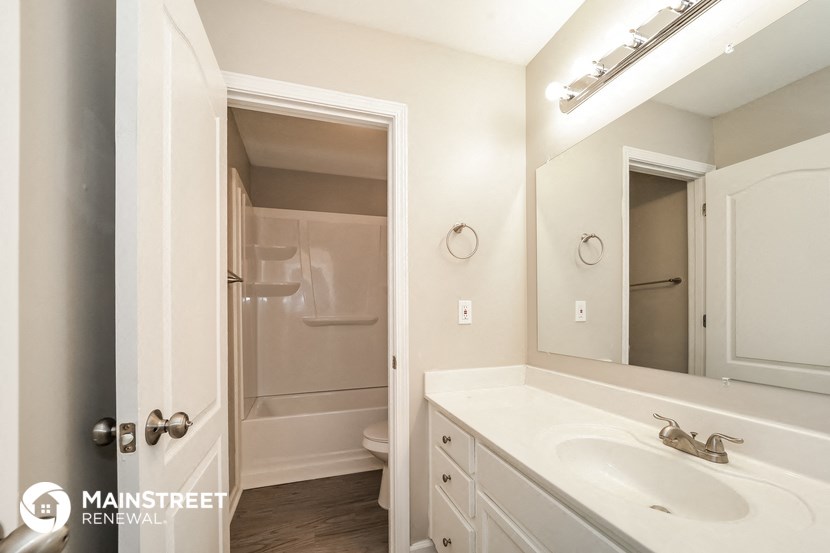 a bathroom with a sink and a mirror and a shower