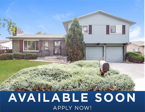 a suburban home with a mailbox in the front yard