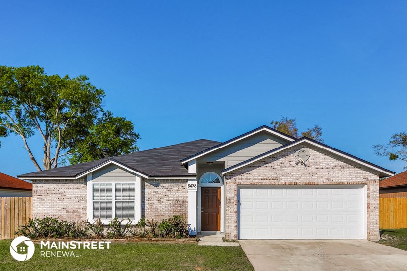 a brick house with a white garage door
