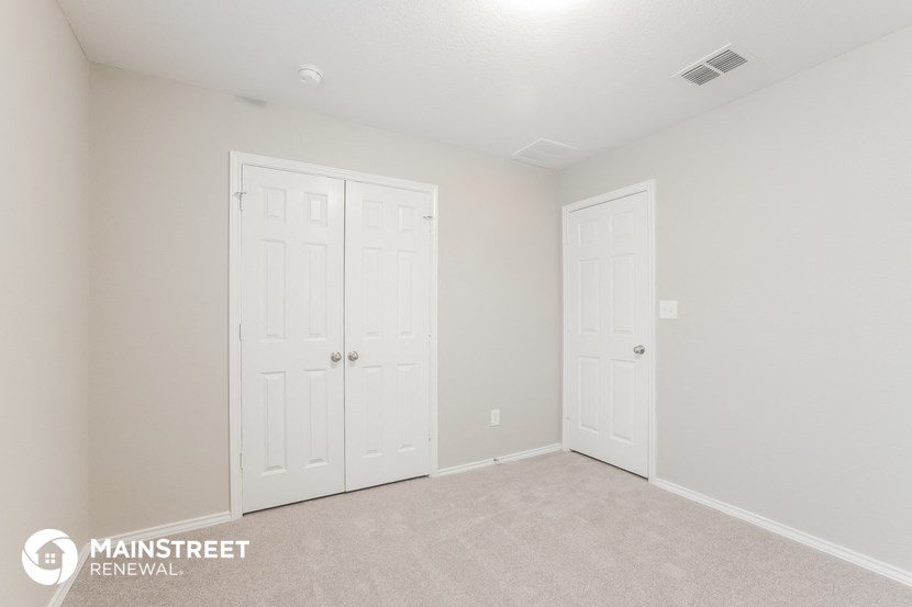 the upstairs bedroom has two closets and a carpeted floor