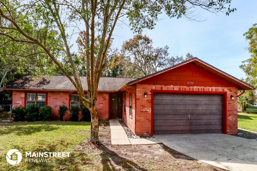 front view of a red house with a garage door